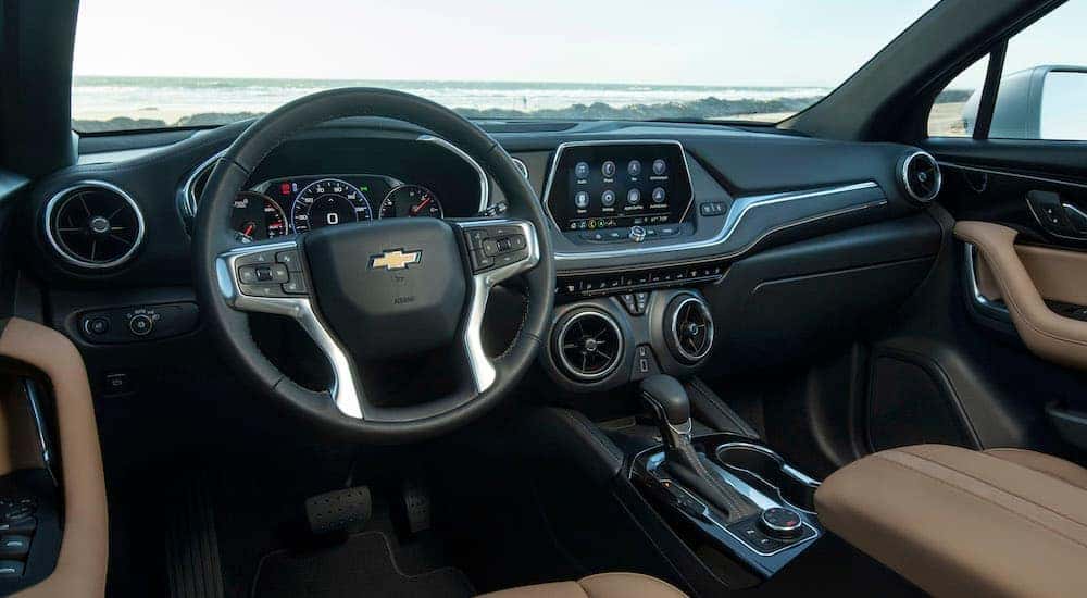The steering wheel and dashboard inside a 2021 Chevy Blazer for sale.