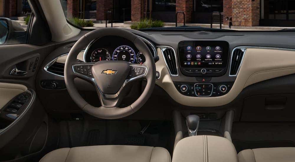 The gray and tan interior and dash is shown in a 2022 Chevy Malibu.