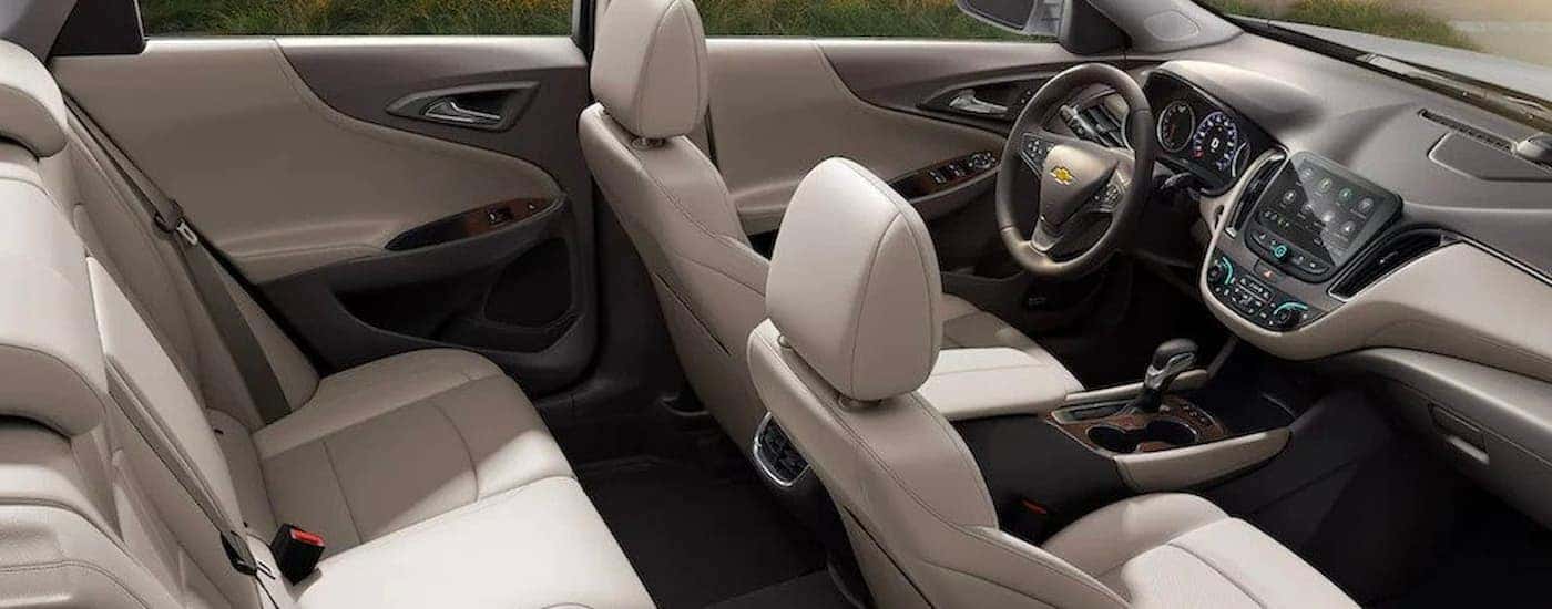 The white and gray interior and dash in a 2023 Chevy Malibu is shown.