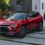 A red 2024 Chevy Blazer RS parked in a driveway.