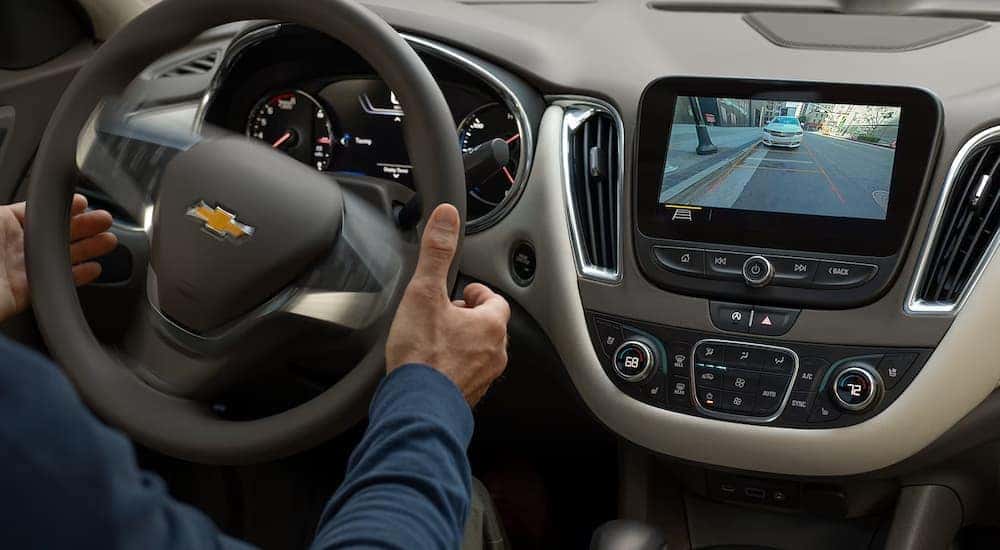 A driver using the parking assist feature in a 2024 Chevy Malibu.