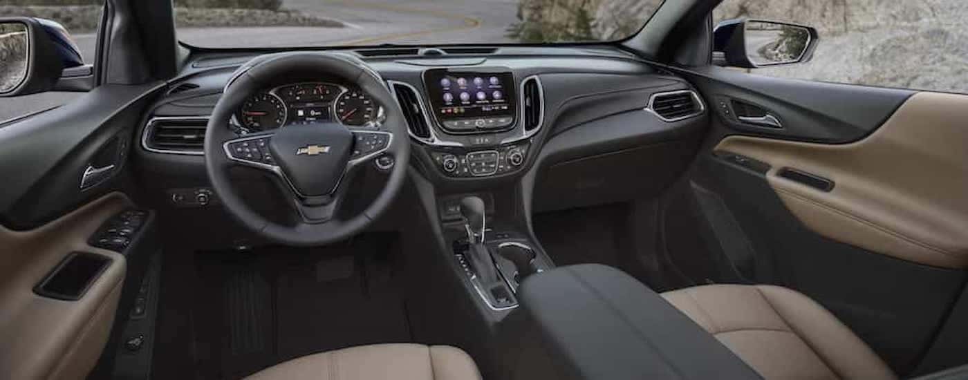 The tan interior of a 2022 Chevy Equinox for sale is shown from the driver's seat.