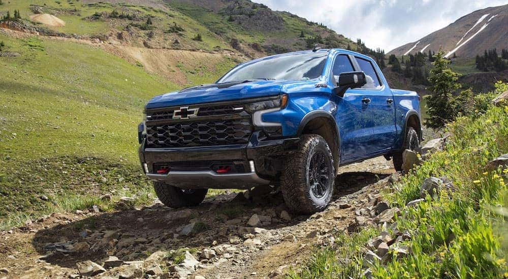 A blue 2022 Chevy Silverado 1500 ZR2 is shown from the front at an angle.
