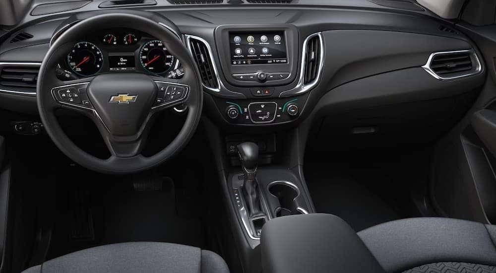 The front seats and dashboard in a 2022 Chevy Equinox LS.