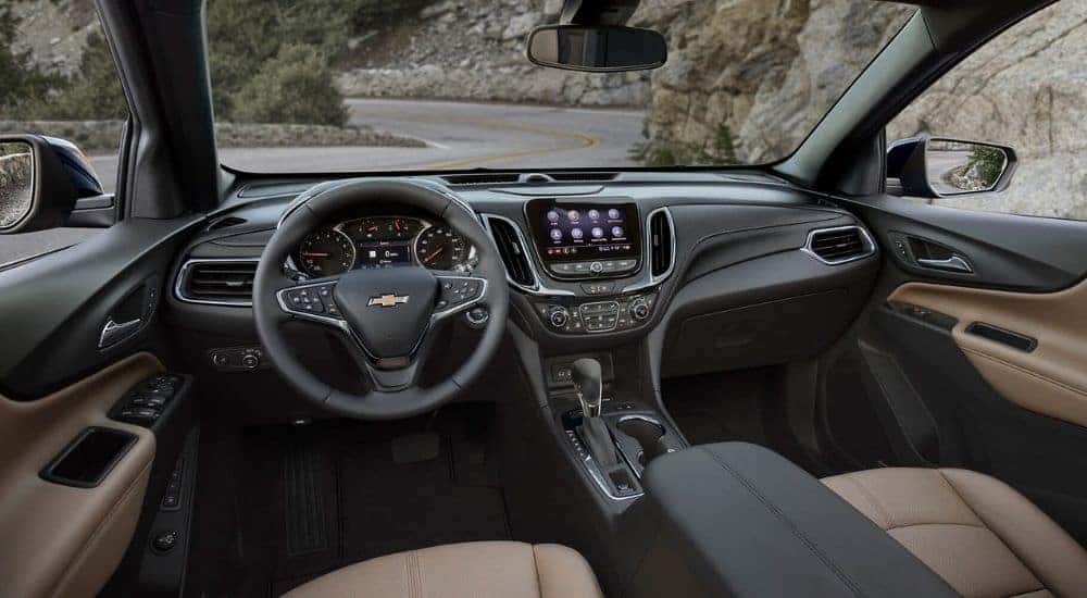 The black and brown interior and dash in a 2022 Chevy Equinox is shown.