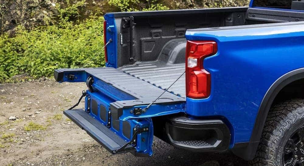 A close-up of the Multi-Flex tailgate is shown on a blue 2024 Chevy Silverado 1500 ZR2.