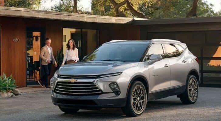 A silver 2024 Chevy Blazer is shown parked on a driveway.