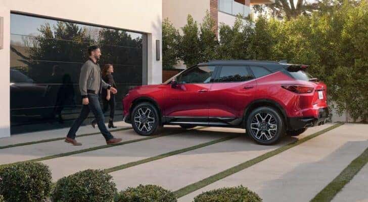 A red 2025 Chevy Blazer RS is shown parked on a driveway.