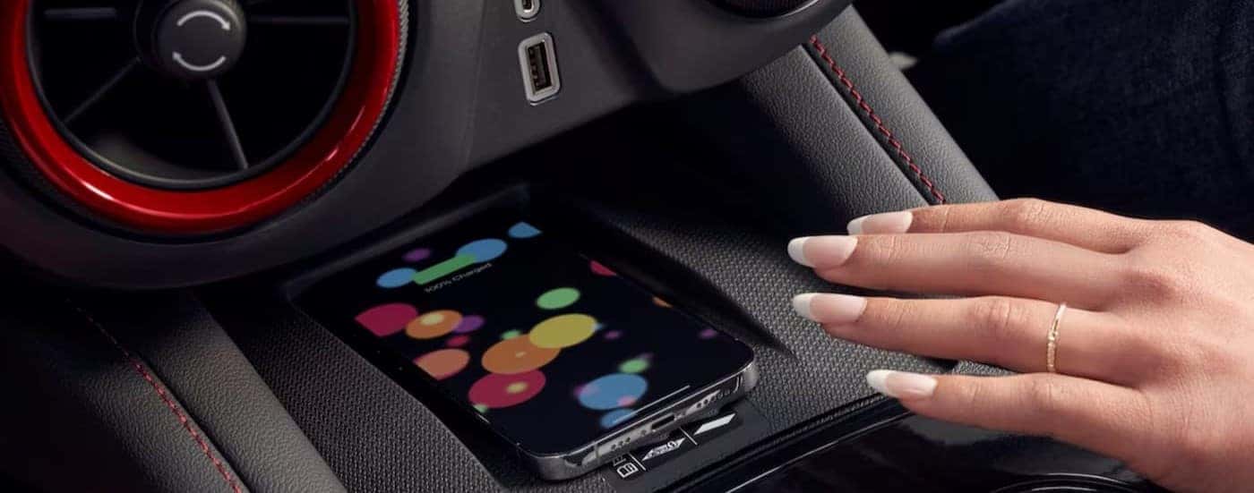 A close-up of the center console with a cell phone on it is shown in a 2025 Chevy Blazer for sale in Indianapolis.
