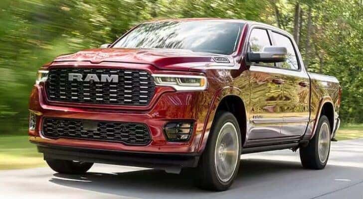 A red 2025 Ram 1500 Tungsten is shown driving after viewing a Ram 1500 for sale.