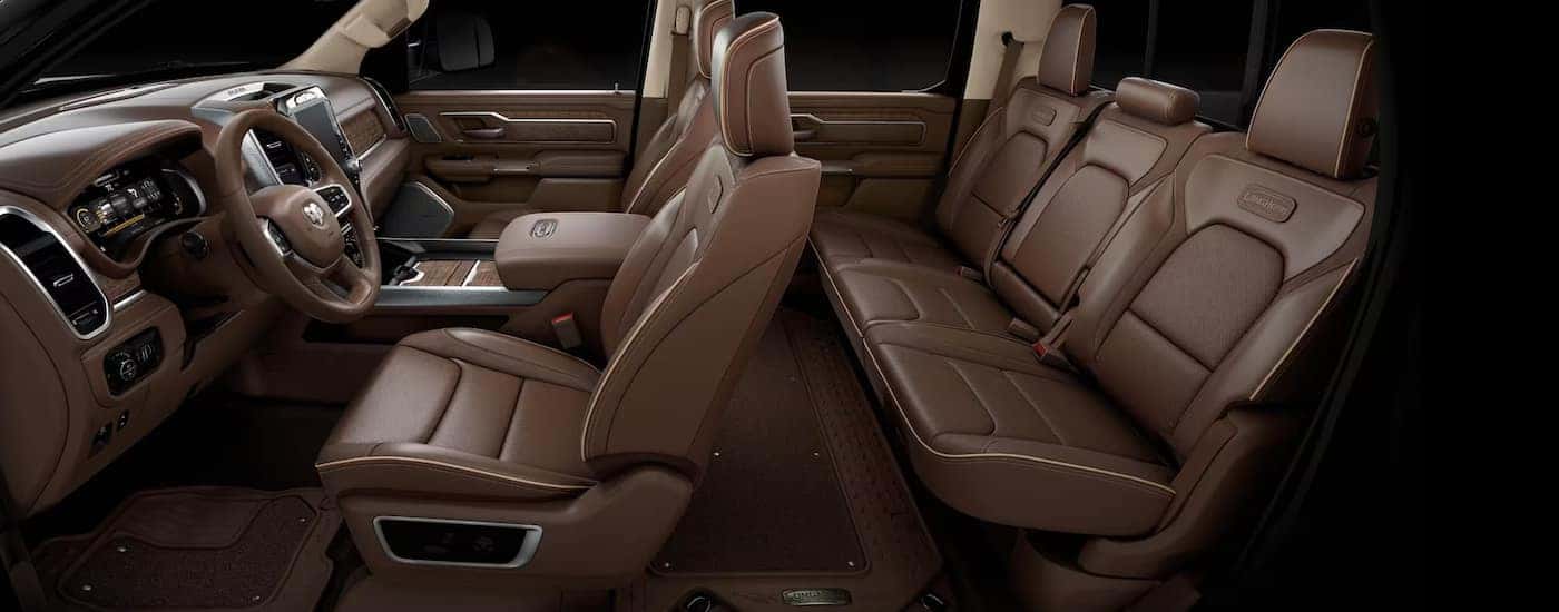 Side view of the brown leather seating in a 2024 Ram 1500 Limited Longhorn, a used Ram 1500 for sale.
