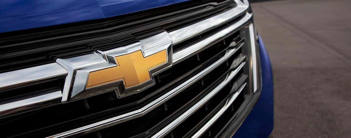 Close-up on the grille and badge of a blue 2023 Chevy Equinox for sale in Cleveland.