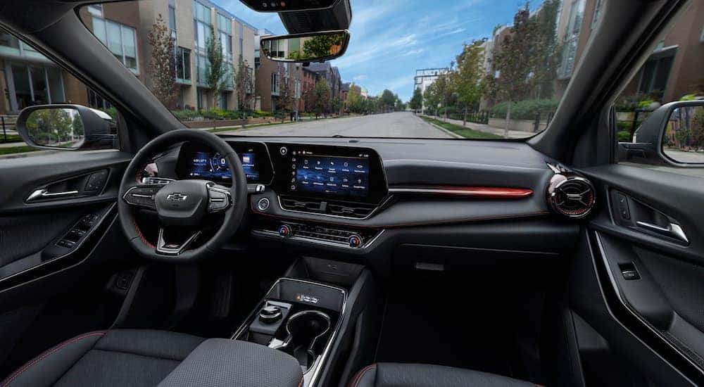 The interior of a 2025 Chevy Equinox RS is shown from the passenger side.