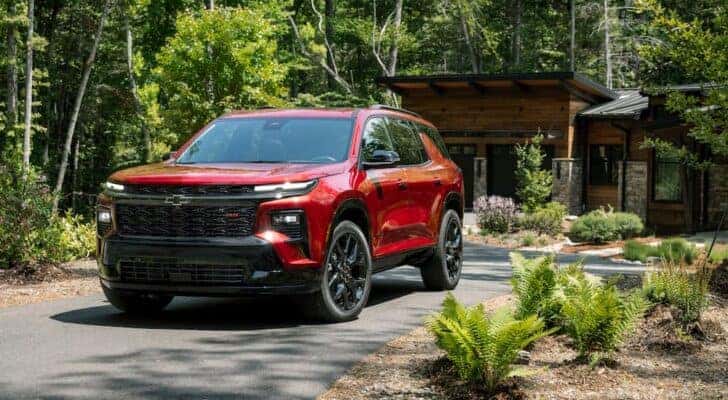 A red 2024 Chevy Traverse is shown from the front at an angle.