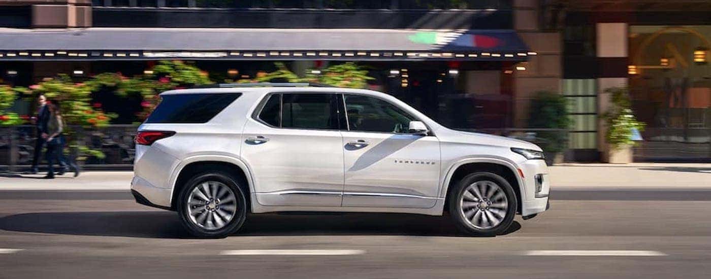 A white 2023 Chevy Traverse for sale is shown from the side.