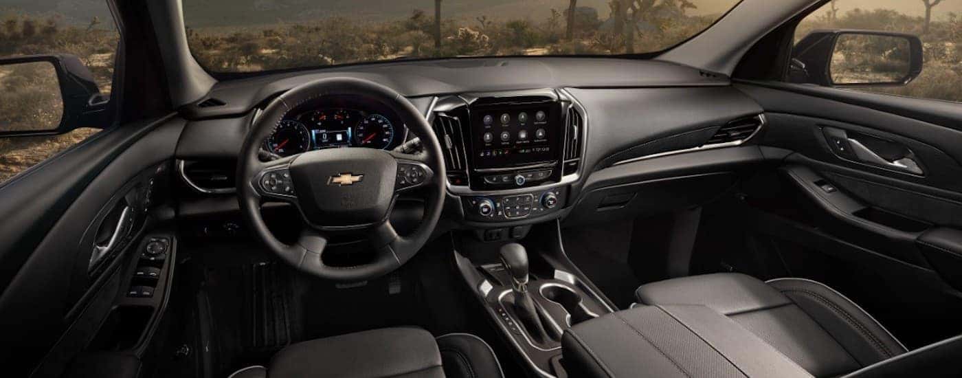The black interior of a 2021 Chevy Traverse is shown from the drivers seat.