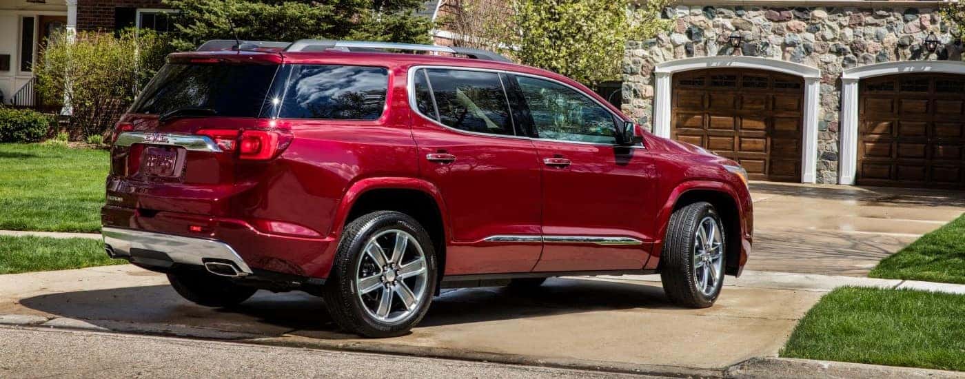 A red 2019 GMC Acadia Denali is shown parked on a driveway.