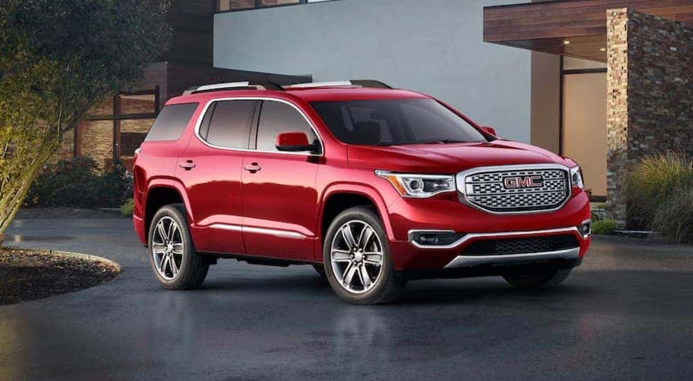 A red 2019 GMC Acadia parked and angled right.