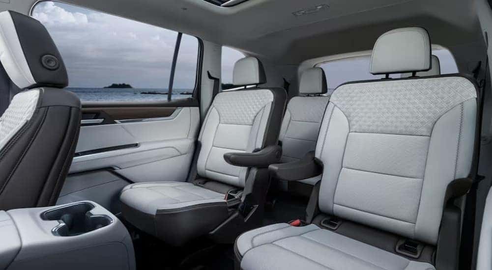 The black and white interior is shown in a 2024 GMC Acadia AT4.