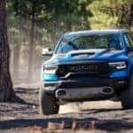 A blue 2023 Ram 1500 TRX is shown off-roading.