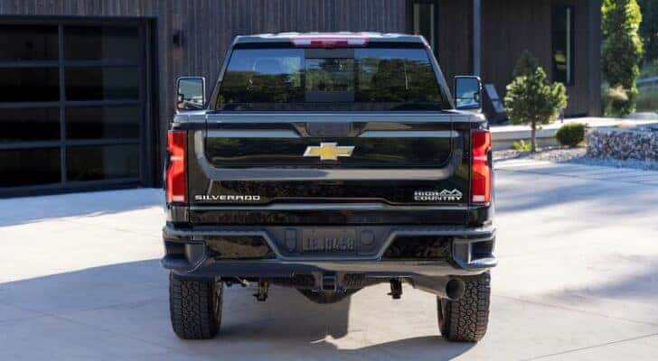 A lack 2024 Chevy Silverado 2500 HD High Country is shown from the rear.