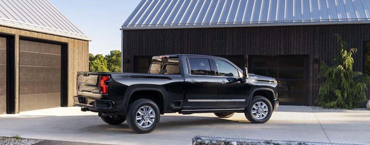 a black 2024 Chevy Silverado 2500 for sale is shown from the side.