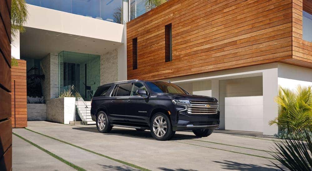 A black 2022 Chevy Suburban for sale is shown from the side.