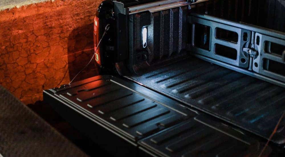 Close-up on the open tailgate of a black 2024 Ram 1500 for sale in Nashville.