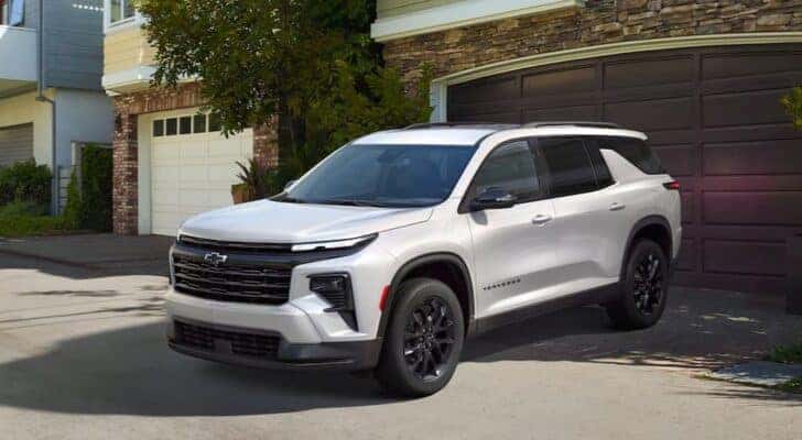 A white 2025 Chevy Traverse for sale in Dallas is shown parked in a driveway.