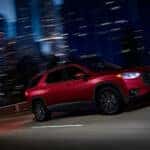 A red 2021 Chevy Traverse RS is shown from the side.