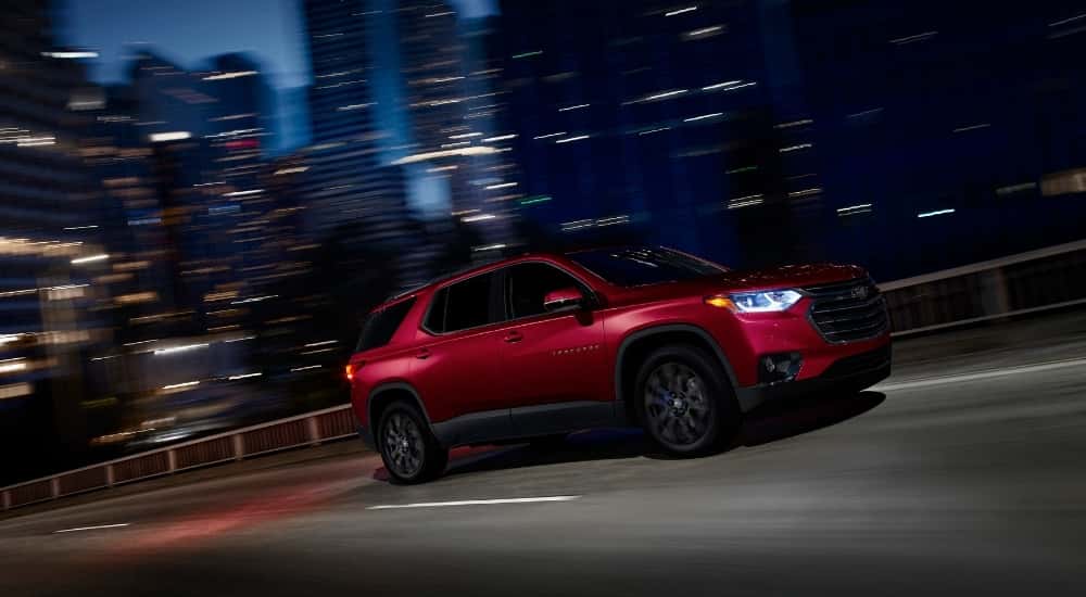A red 2021 Chevy Traverse RS is shown from the side.