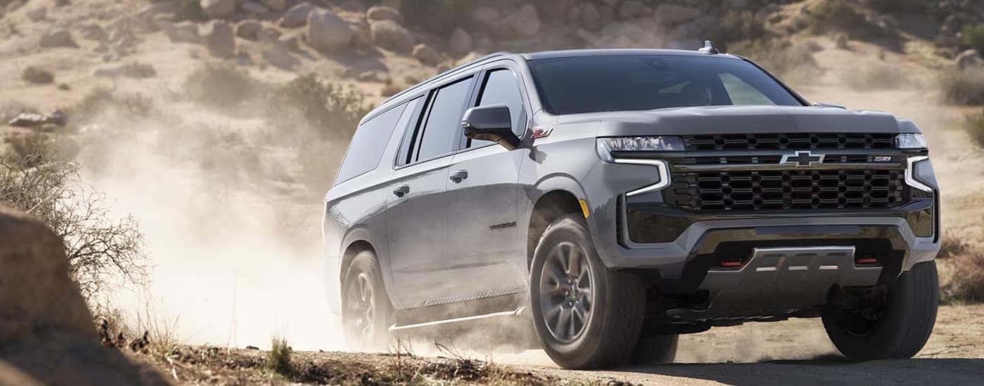 A silver 2023 Chevy Suburban Z71 driving off-road.