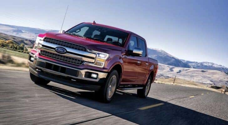 A red 2020 Ford F-150 driving in a desert from a dealer with a used Ford F-150 for sale.