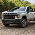 A white 2023 Chevy Silverado 2500 for sale is shown from the front at an angle.