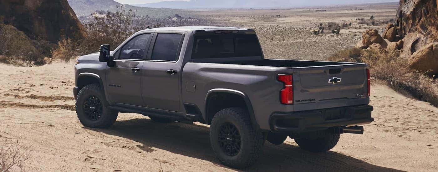 Rear view of a grey 2024 Chevy Silverado 2500 ZR2 parked off-road.