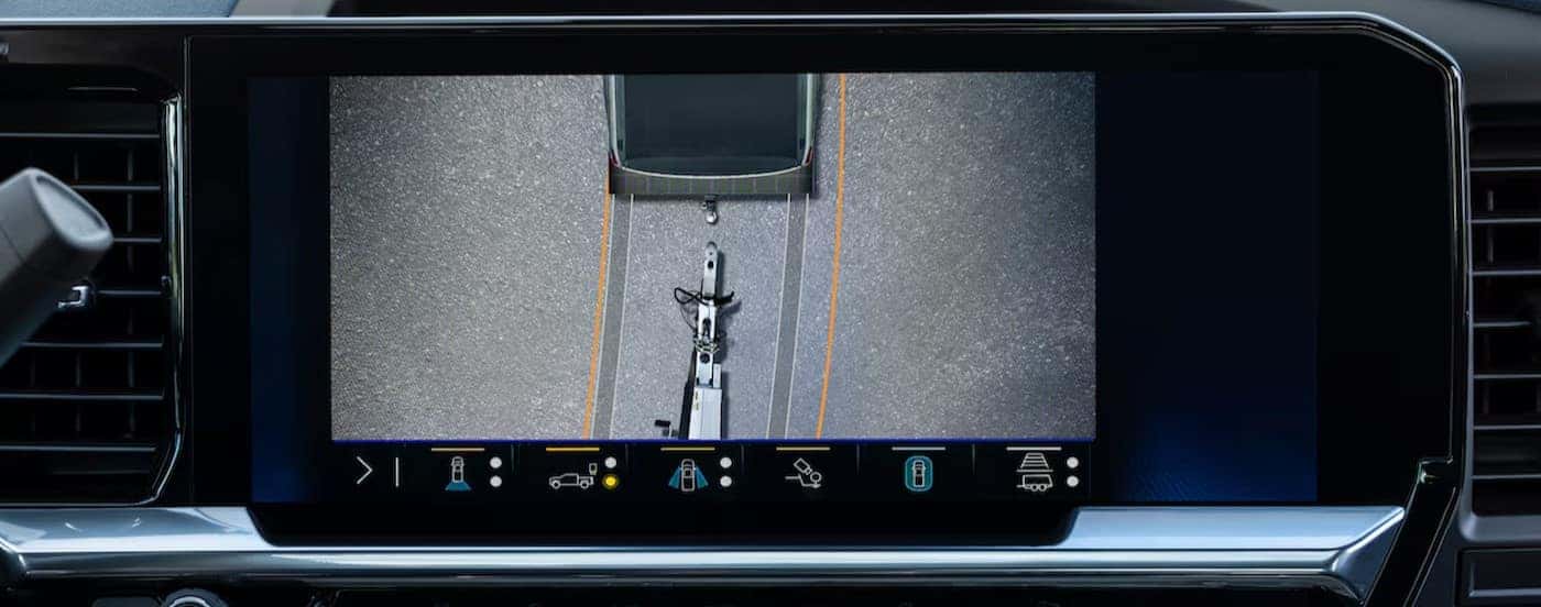A close-up of the infotainment screen is shown in a 2025 used Chevy Silverado 2500 for sale.