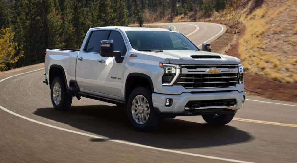 A white 2024 Chevy Silverado 2500 for sale is shown from the front at an angle.