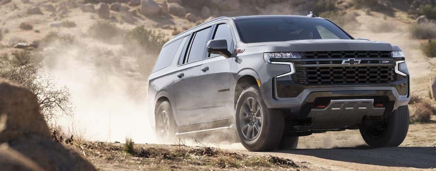 A grey 2024 Chevy Suburban Z71 driving off-road.