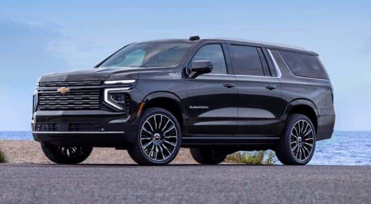 A black 2025 Chevy Suburban High Country parked and angled left.
