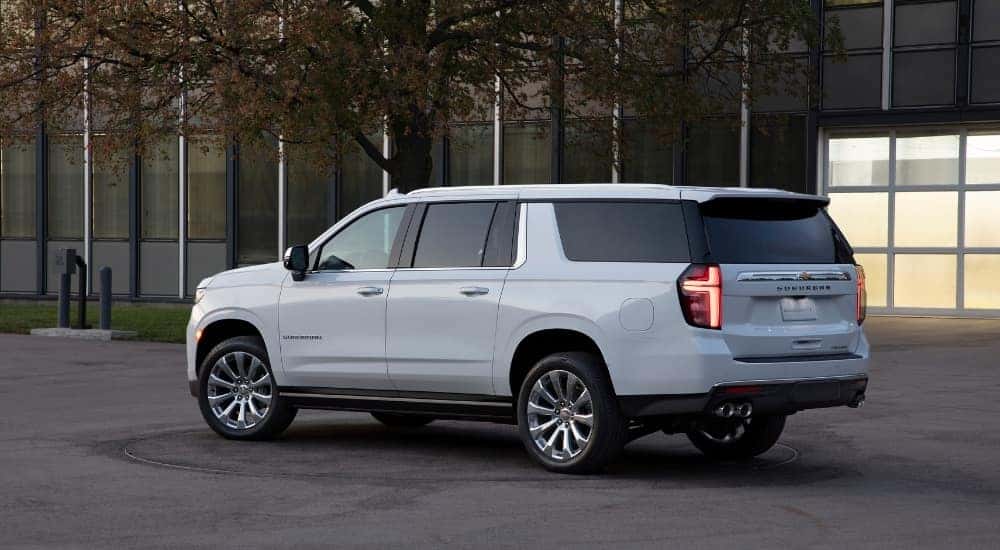 A white 2021 Chevy Suburban is shown from the side.