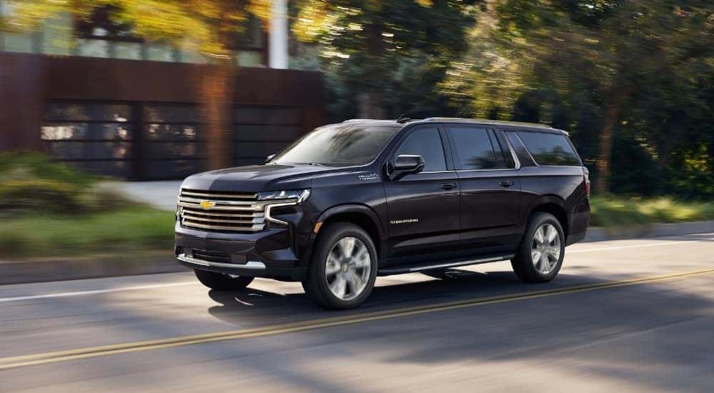 A grey 2023 Chevy Suburban High Country is shown.