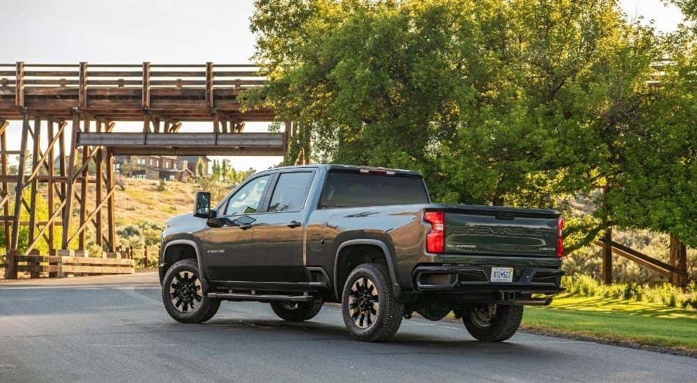 A grey 2024 Chevy Silverado 2500 is shown from the rear at an angle.