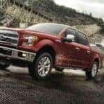 A red 2017 Ford F-150 is shown pulling a boat up a ramp.