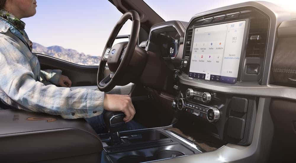 A person driving a 2021 Ford F-150.