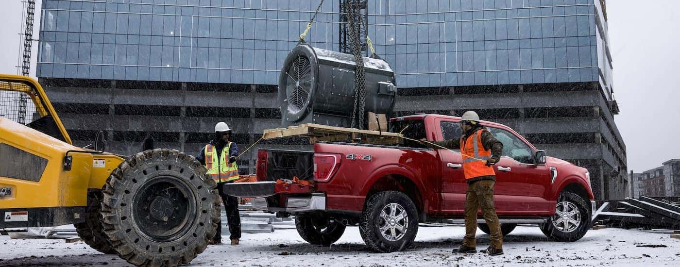 A red 2023 Ford F-150 is shown from the side.