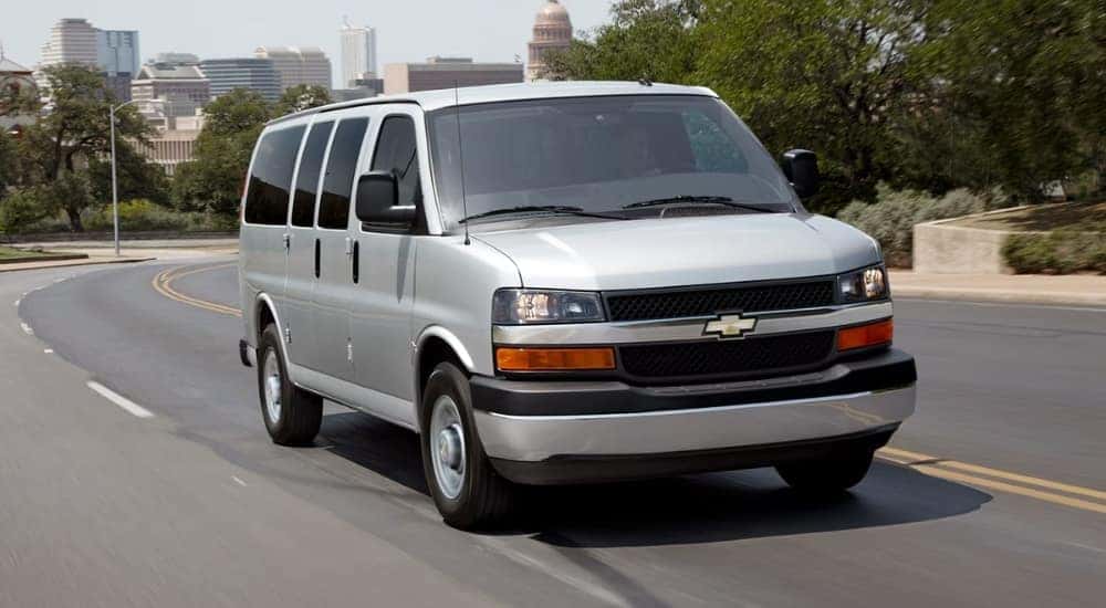 A silver Chevy Express 2500 on the highway.