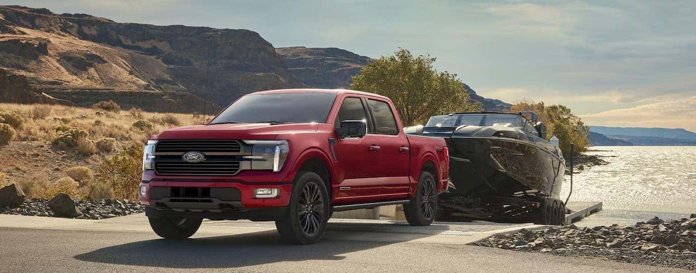 A red 2024 Ford F-150 is shown from the front at an angle.