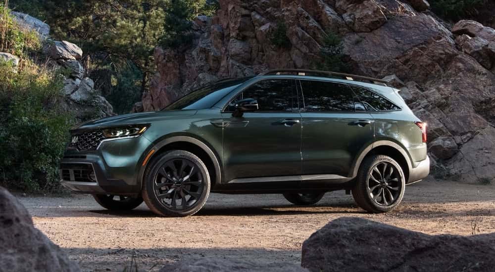 Side view of a green 2022 Kia Sorento X-Line parked off-road.