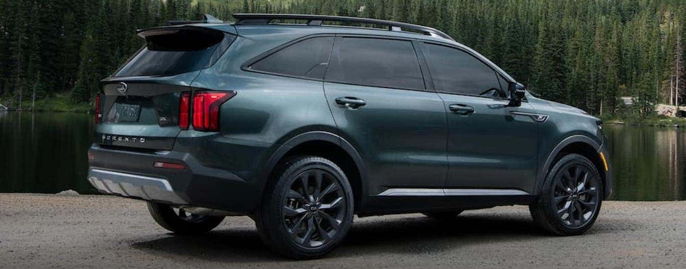 A blue 2023 Kia Sorento is shown from the side.