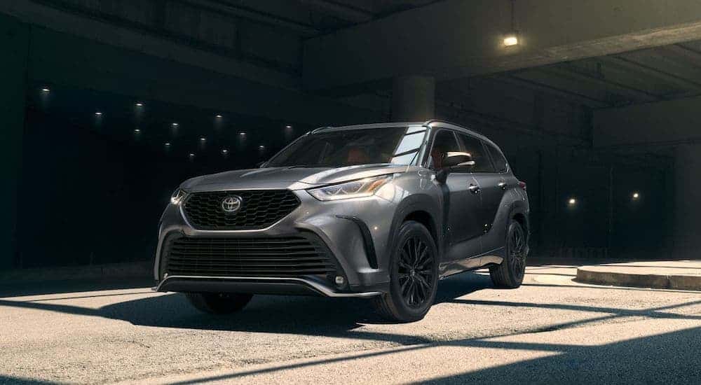 A grey 2024 Toyota Highlander parked in a parking garage.
